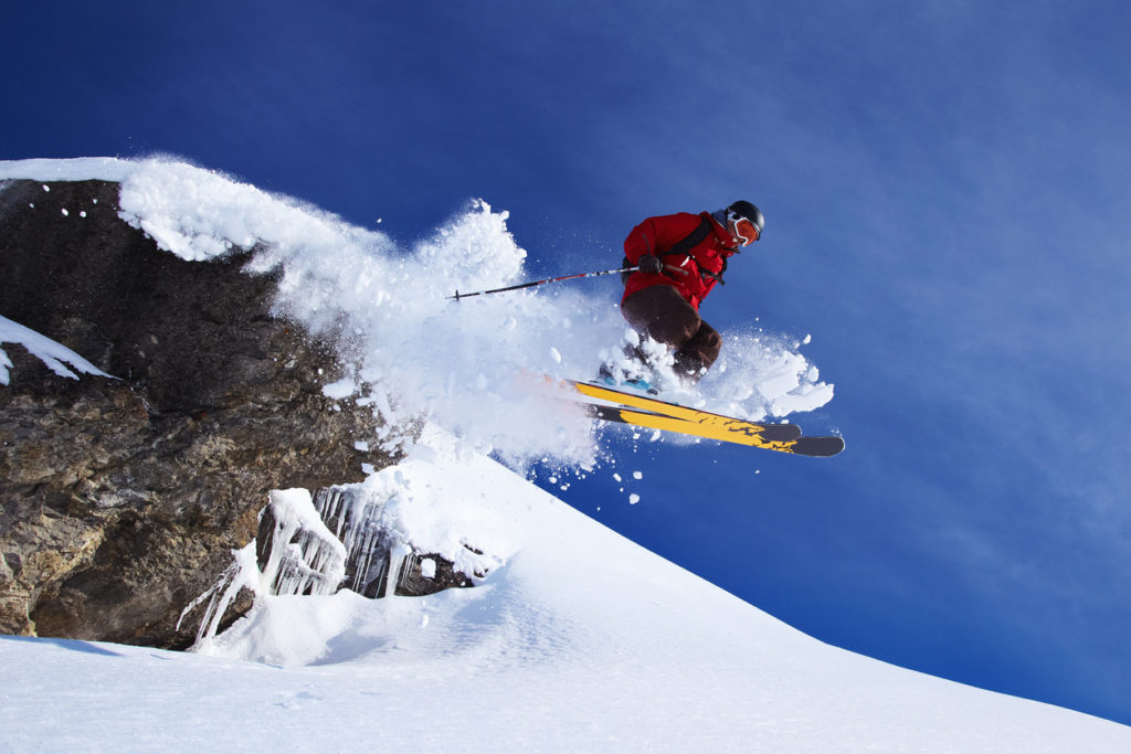 Skier jumping on snowy slope